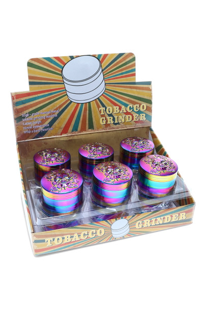 Bulk wholesale display of 12 rainbow zinc alloy skull grinders, 52 mm diameter, countertop retail box, front angle view