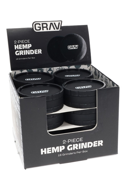 Wholesale display of 16 GRAV 2-piece hemp plastic grinders, black with logo, counter POP box front angle for smoke-shop merchandising.
