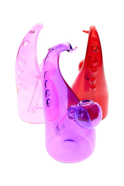 Three 5.5" colored glass tentacle oil burner rigs in pink, purple, and red on white—wholesale head-shop front three-quarter view.