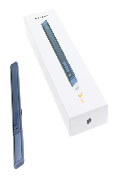 Storm color Puffco Hot Knife shown with retail box, ceramic tip illustrated dripping extract; clean angled product shot for B2B smoke-shop listings.