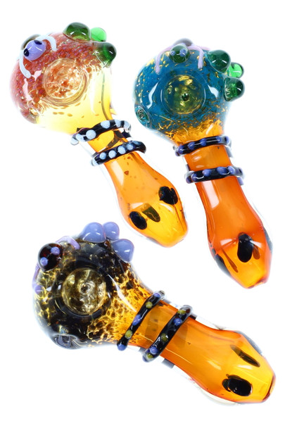 Gold-fumed frit critter glass spoon pipes, 4.5" length, assorted colors with marble accents, top-down studio view for wholesale product listings Gold-fumed frit critter glass spoon pipes, 4.5" length, assorted colors with marble accents, top-down studio view for wholesale product listings