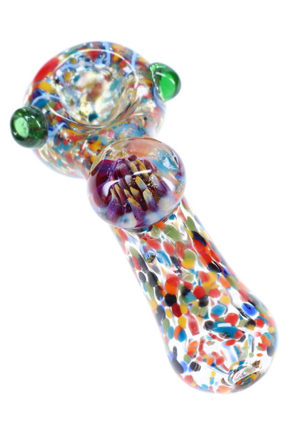 5" thick color-changing confetti frit glass spoon with raised floral marble and green bowl nubs; wholesale head-shop photo, angled close-up. 5" thick color-changing confetti frit glass spoon with raised floral marble and green bowl nubs; wholesale head-shop photo, angled close-up.