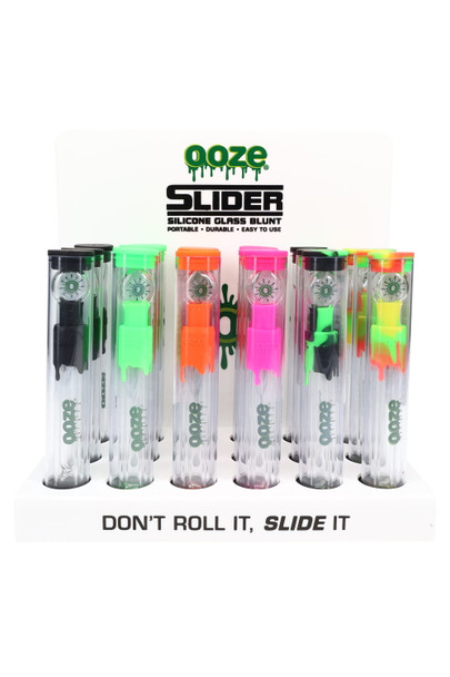 Retail display of 18 Ooze Slider silicone glass blunts in assorted colors with “Don’t Roll It, Slide It” header card, front view for smoke-shop wholesale. Retail display of 18 Ooze Slider silicone glass blunts in assorted colors with “Don’t Roll It, Slide It” header card, front view for smoke-shop wholesale.
