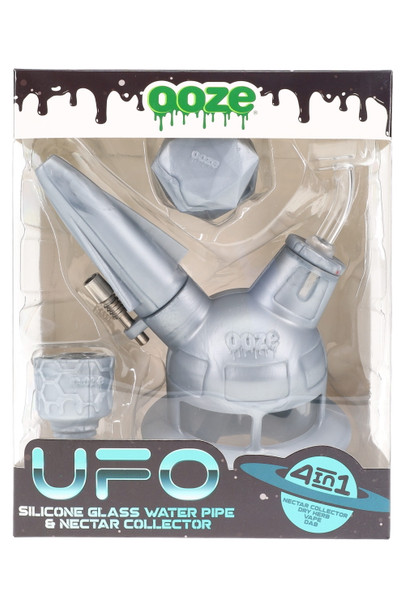Silver/grey Ooze UFO silicone/glass 4-in-1 water pipe packaged in window box with accessories displayed, front view optimized for retail smoke-shop wholesale. Silver/grey Ooze UFO silicone/glass 4-in-1 water pipe packaged in window box with accessories displayed, front view optimized for retail smoke-shop wholesale.