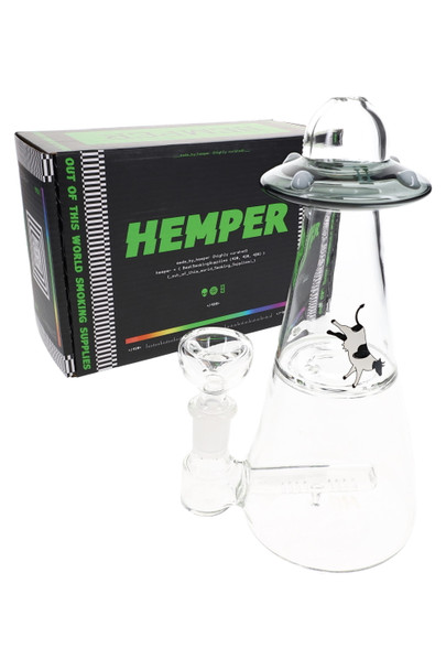 Hemper UFO Vortex 6" bong in smoke color posed before black “Out of This World Smoking Supplies” Hemper box, shelf-ready setup for retailers.