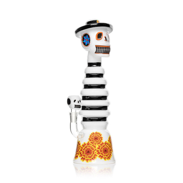 Side angle of 13" Hemper Dia De Los Muertos XL skull bong, striped neck and marigold base, studio shot for smoke shop buyers.