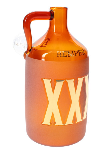 Amber Hemper Wild West moonshine bottle glass bong with frosted XXX label and side handle, close studio view for smoke shop wholesale listings.