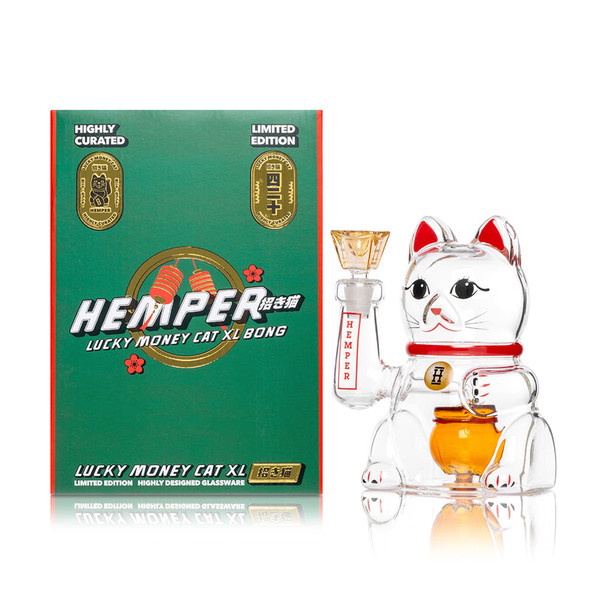 Hemper Lucky Money Cat XL bong posed beside green Lucky Money Cat XL Bong retail box, shelf-ready character water pipe presentation for B2B glass listings.