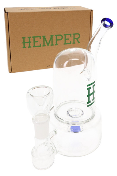 Hemper 7" Bell Bong in front of kraft HEMPER shipping box, showing clear bell dome and blue mouthpiece, shelf-ready water pipe set for smoke shop buyers.