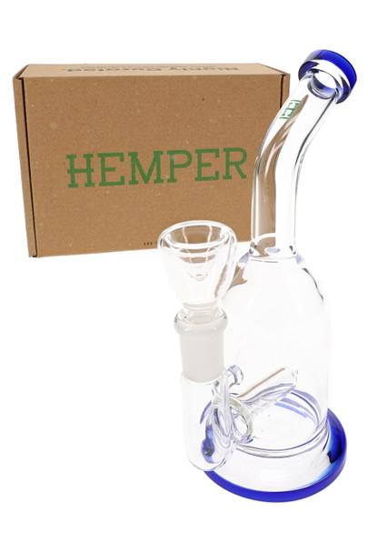 Hemper Whistler mini bong with blue accents posed in front of kraft Hemper box and clear bowl, shelf-ready glass rig display shot for head-shop buyers.