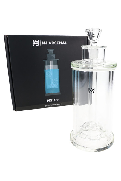 MJ Arsenal Piston Gravity Bong beside branded box, clear borosilicate glass; wholesale water pipe for display cases.