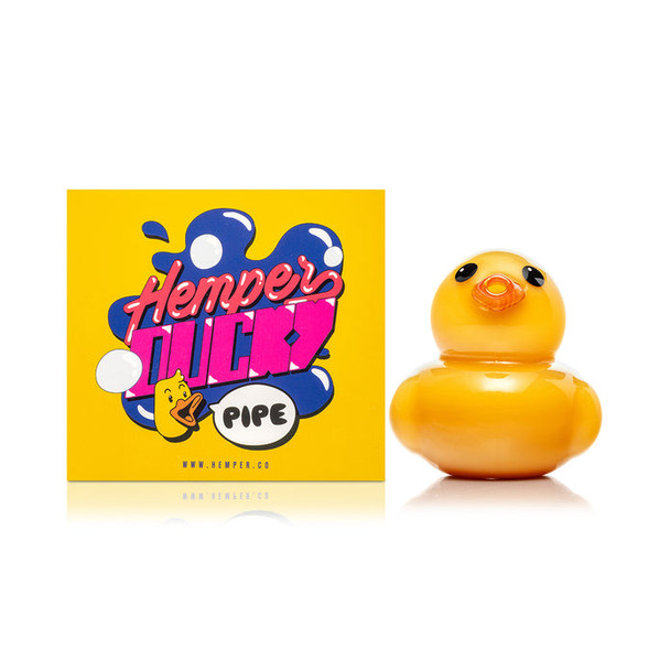 Hemper Ducky glass hand pipe posed next to yellow retail box, front-facing counter display for retailers