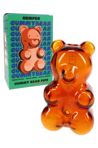 Amber gummy bear glass hand pipe beside Hemper retail box, showcase-ready smoke shop inventory hero shot