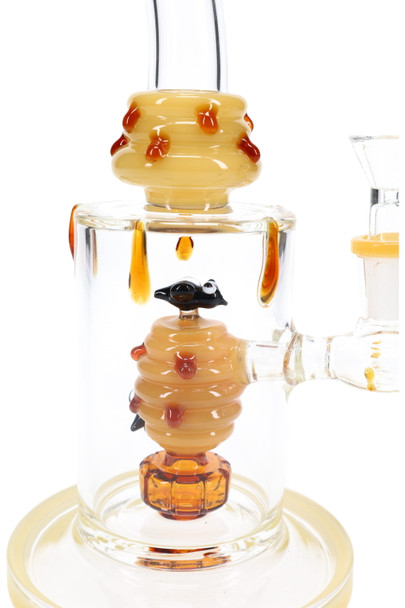 Close-up of amber bee showerhead perc inside bent-neck straight shooter water pipe—wholesale glass detail view