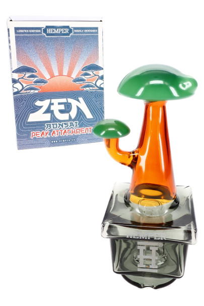 Zen Bonsai Puffco Peak top posed with branded box, green mushroom-like top and amber glass, retail smoke gear