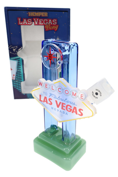 Angled Las Vegas sign XL bong with Hemper box behind, blue glass frame and green base—B2B resale packaging view