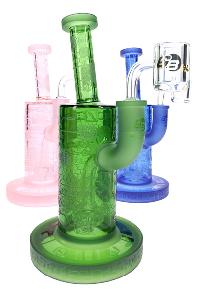Assorted pink, green, and blue wholesale dab rigs with frosted biotech graphics and compact stemless bodies.
