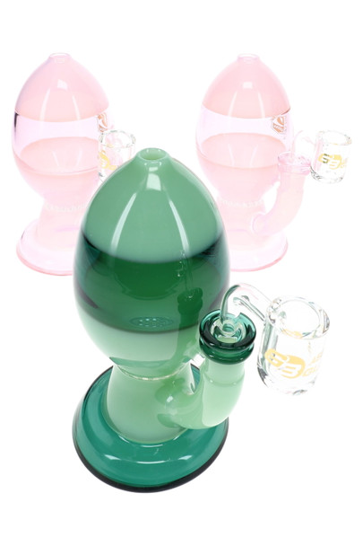 Assorted pink and green wholesale egg dab rigs with honeycomb perc and clear quartz bangers for showcase display.