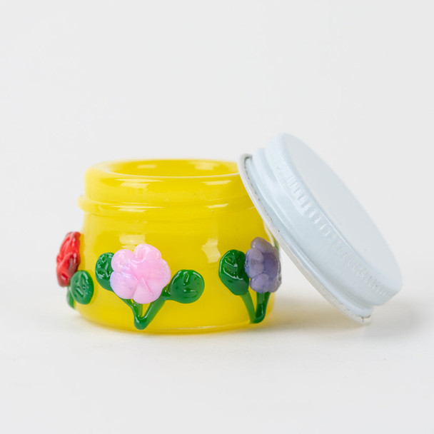 Open Sunshine Garden glass terp jar for wholesale dab accessories, showing white lid and yellow interior