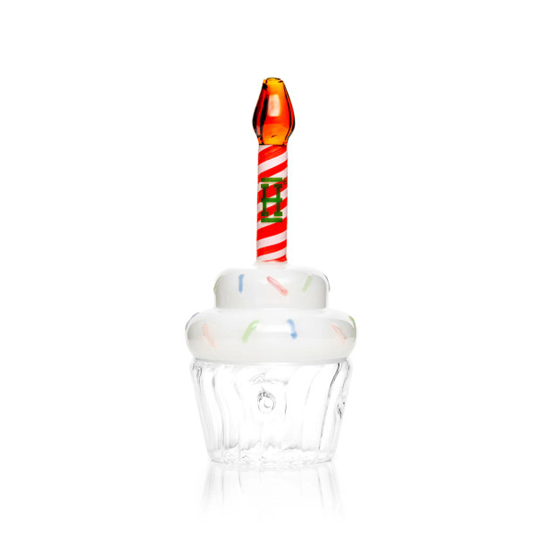 Cupcake-shaped glass hand pipe with white sprinkle top, clear base, and red swirl candle stem