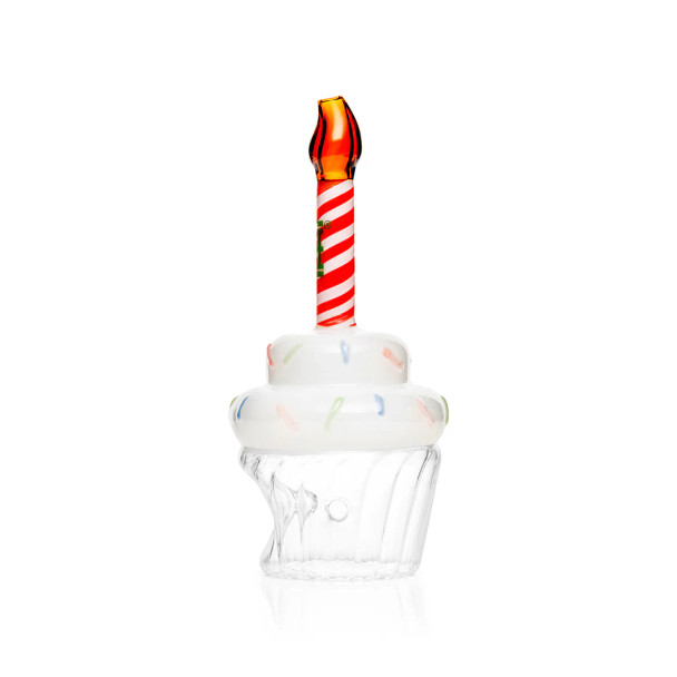 Alternate angle of cupcake glass hand pipe with clear base, white frosting detail, and orange flame tip