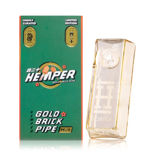 Hemper Gold Brick Hand Pipe beside green retail box with gold badge artwork and brick pipe branding