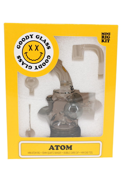 Goody Glass Atom Mini Rig Kit in yellow retail box with smoke-colored rig, quartz banger, carb cap, and dab tool visible through window