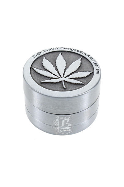 Compact leaf design metal grinder shown at angle for retail counter merchandising