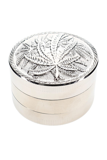 Leaf design metal grinder displayed at angle for smoke shop accessory merchandising