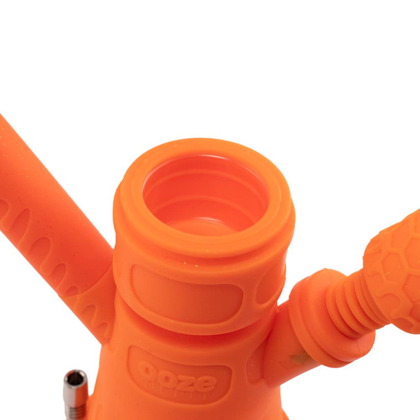 Close-up of Ooze Hyborg Orange Burst silicone chamber opening and integrated accessory connection points