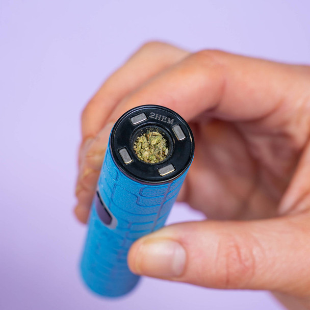 Close-up of Ooze Pinch dry herb chamber loaded with ground material and magnetic heating system