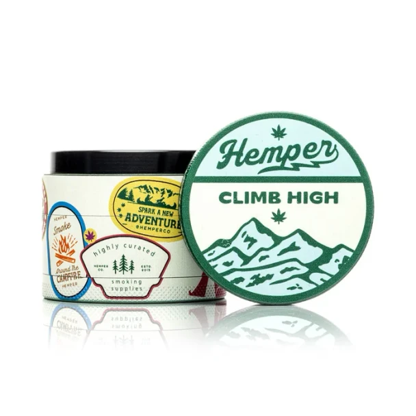 Closed Hemper Happy Camper 4-part grinder showing outdoor-inspired artwork on a white background
