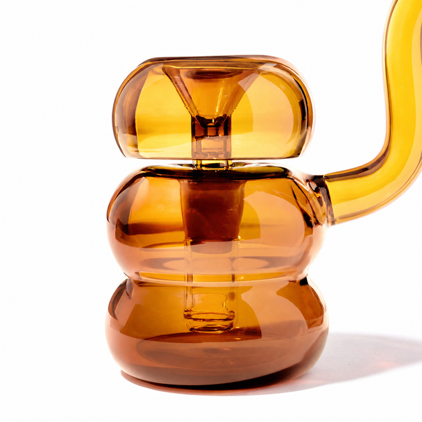 Side profile of the Baltic Amber NWTN Bolla bubbler with removable bowl positioned above the rounded water chamber.