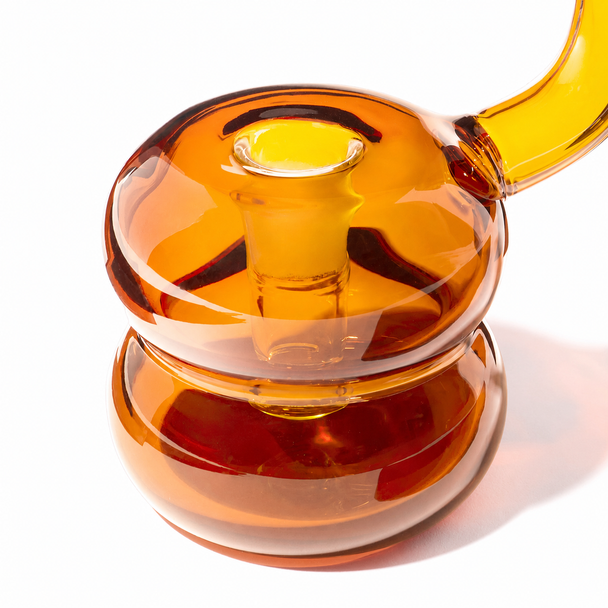 Close-up of the Baltic Amber NWTN Bolla bubbler highlighting the integrated bowl opening and rounded borosilicate glass chamber.