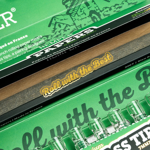 Close-up of open HEMPER Natural Brown combo pack with rolling papers and clear glass tips visible below