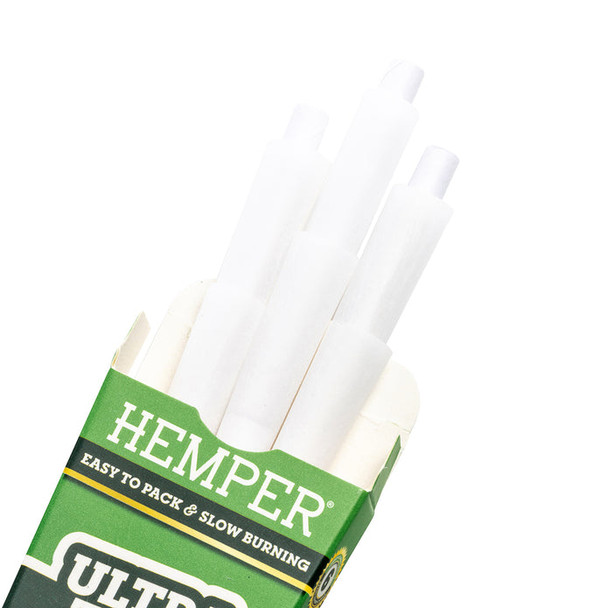 Close-up of white HEMPER Ultra Thin 1 1/4 pre-rolled cones inside opened green retail pack