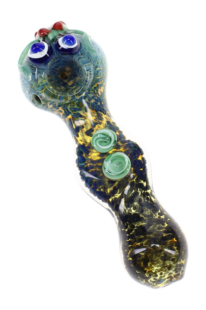 Close-up fumed frit glass spoon pipe with blue-and-white critter eyes, green glass accents, and raised marbles