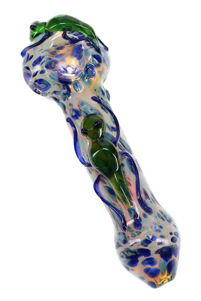 Close-up critter glass spoon pipe with green sculpted figure, blue accents, fumed glass pattern, and rounded bowl