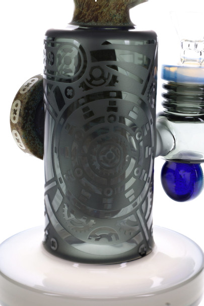 Close-up of dark frosted glass body with etched geometric gear patterns and blue accent below bowl joint