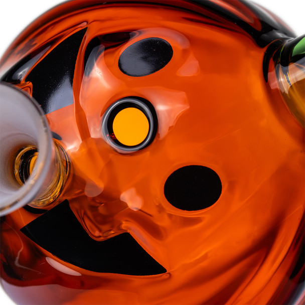 Close-up of Jack O'Ripper pumpkin face showing black facial details, front carb, and frosted cone opening