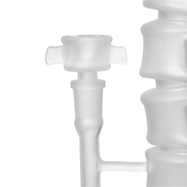 Close-up of matching frosted Skele-Tube bowl and glass downstem beside the bong’s segmented spine body