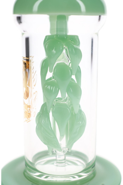 Close-up of sculpted mint green leaves winding around the internal vine percolator inside a clear glass chamber.