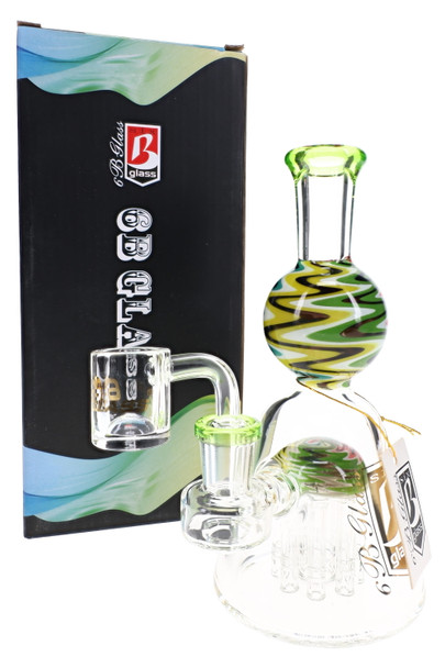6B Glass dab rig with green mouthpiece, multicolor zigzag neck, clear banger, and branded box.