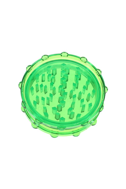 Top-down closeup of green 2-part acrylic grinder teeth, compact 3" size for smoke shop inventory