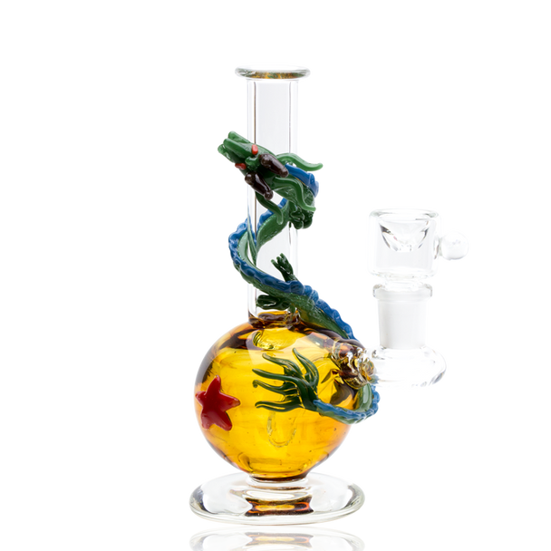 Dragon Sphere mini rig on white, amber chamber with red star and green dragon coil—compact 6.5" head-shop display piece with ground glass joint.