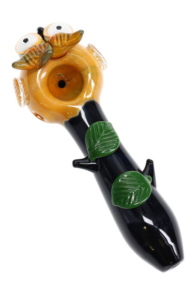 Side angle white cutout of amber owl spoon with black branch-like stem and two green leaves—compact 4.5" retail smoke gear piece. Side angle white cutout of amber owl spoon with black branch-like stem and two green leaves—compact 4.5" retail smoke gear piece.