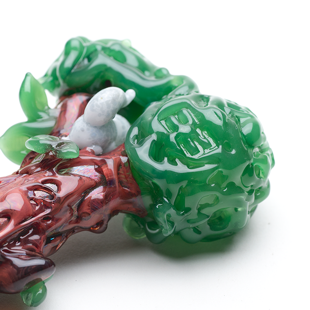 Front view of 4" Squirrel’s Nest spoon with deep green bowl and leaf accents on white—wholesale head-shop glass hand pipe, lightweight display shot.