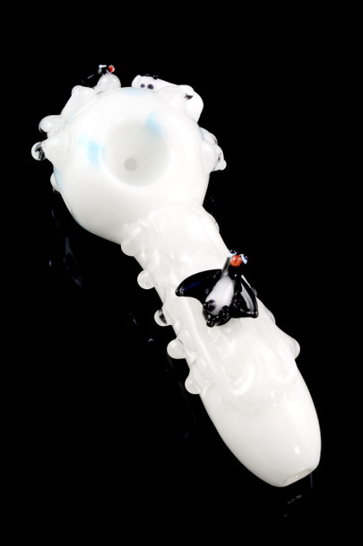 Angled studio view of 4.5" white glass spoon with aqua bowl and sculpted penguin on black—wholesale head-shop product shot showing raised ice-like marbles.