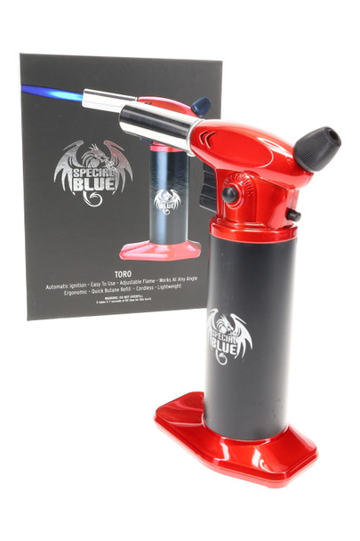 Special Blue Toro torch for wholesale buyers, red and black tabletop butane model, three-quarter left angle with retail packaging in background. Special Blue Toro torch for wholesale buyers, red and black tabletop butane model, three-quarter left angle with retail packaging in background.