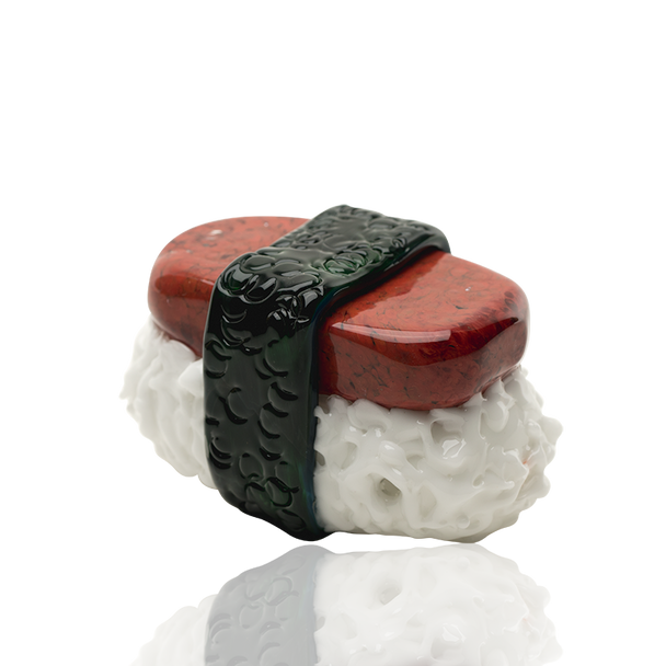 Side three-quarter product view for retail smoke gear—Spam Musubi novelty dry pipe, 3.5" glass with raised nori wrap and rice texture on white backdrop.